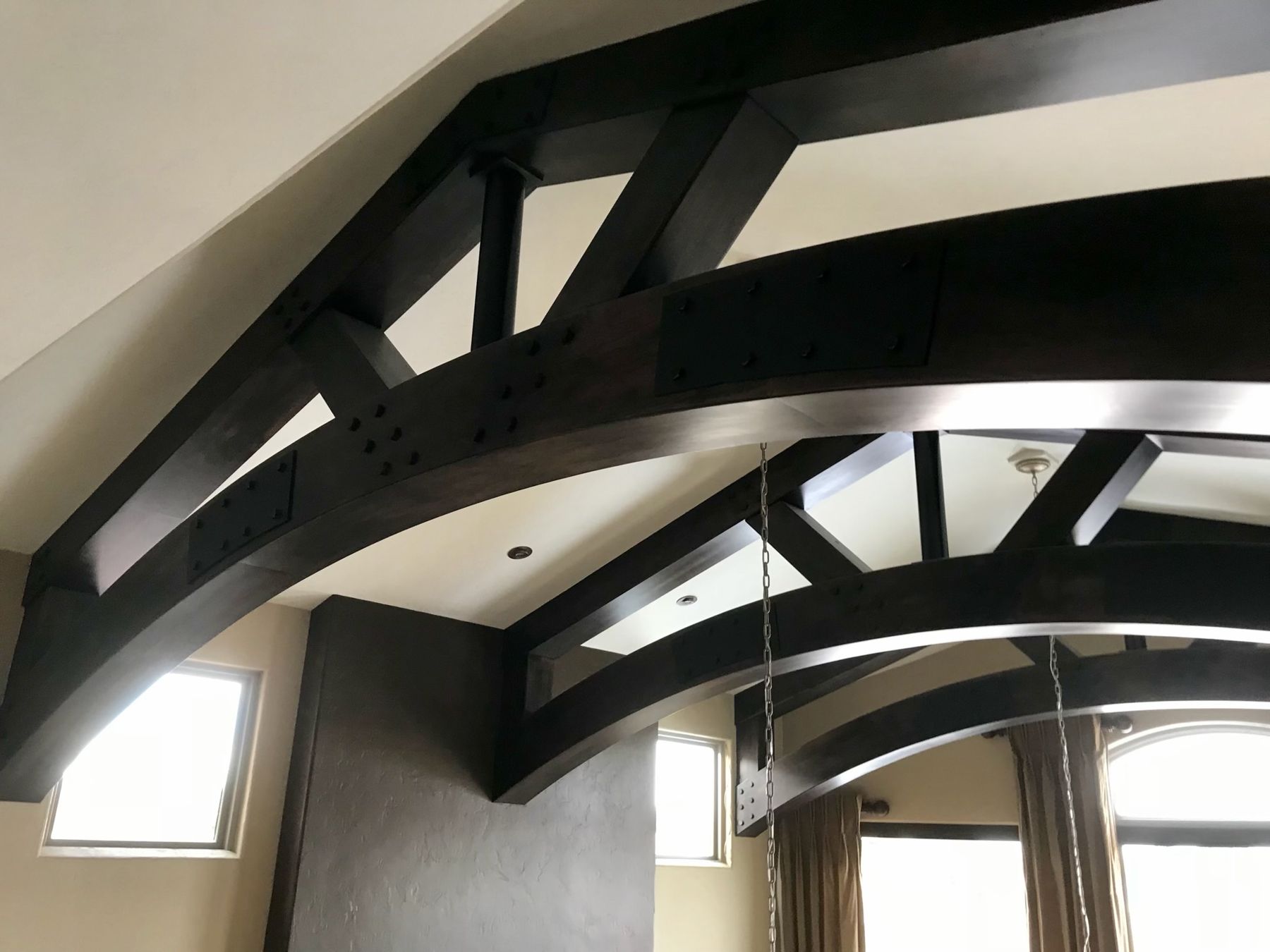 Dark curved timber trusses
